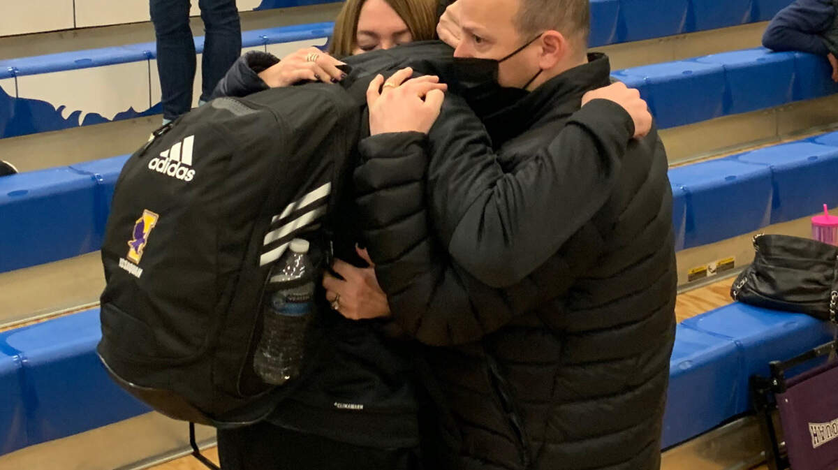 Richard and Stacey Eastern comfort their son Zach on Friday, Feb. 4, after Issaquah High School’s basketball team lost to rival Bothell in a tournament game.