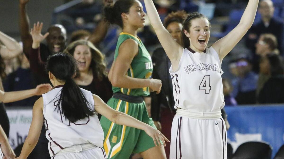 Mercer Island’s Claire Mansfield (4) celebrates her team’s victory in the 3A girls championship game Saturday. Mansfield made a late pickoff to seal the win at the Tacoma Dome.