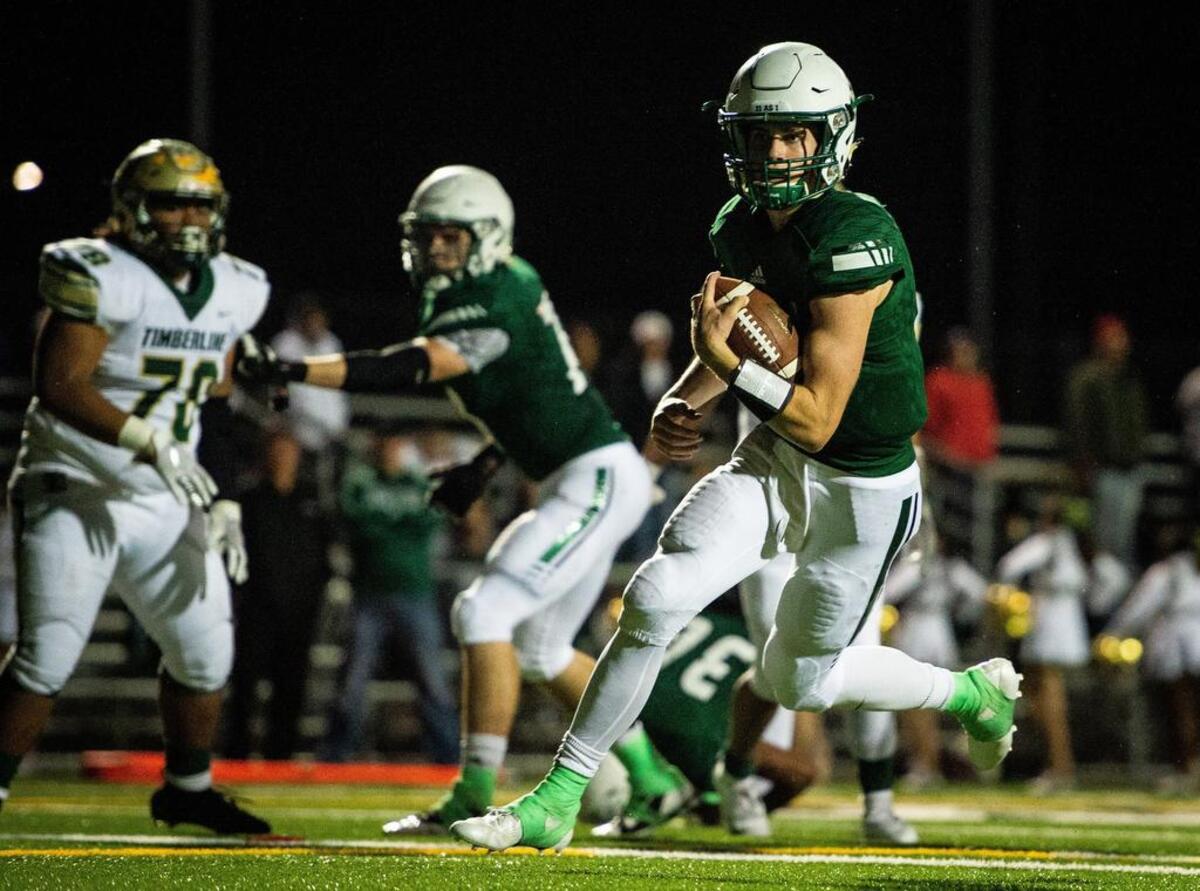 Peninsula’s Burke Griffin (5) scrambles for a touchdown in the second quarter. Peninsula High School played Timberline High School in a football game at Roy Anderson Field in Purdy, Wash., on Thursday, Sept. 27, 2018.