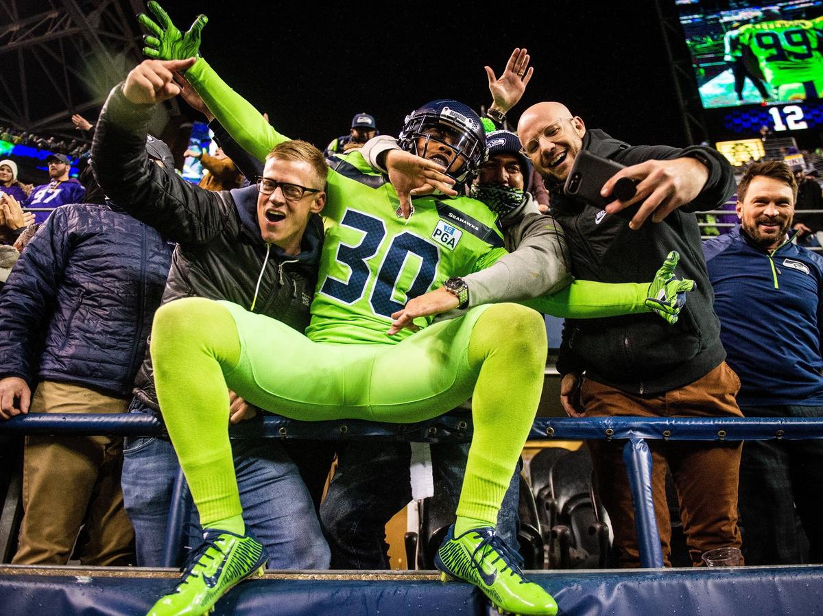 Seahawks safety Bradley McDougald (30) leaps into the stands in celebration after Seahawks corner back Justin Coleman returned a fumble for a touchdown in the fourth quarter. The Seattle Seahawks played the Minnesota Vikings in a NFL football game at CenturyLink Field in Seattle, Wash., on Monday, Dec. 10, 2018.