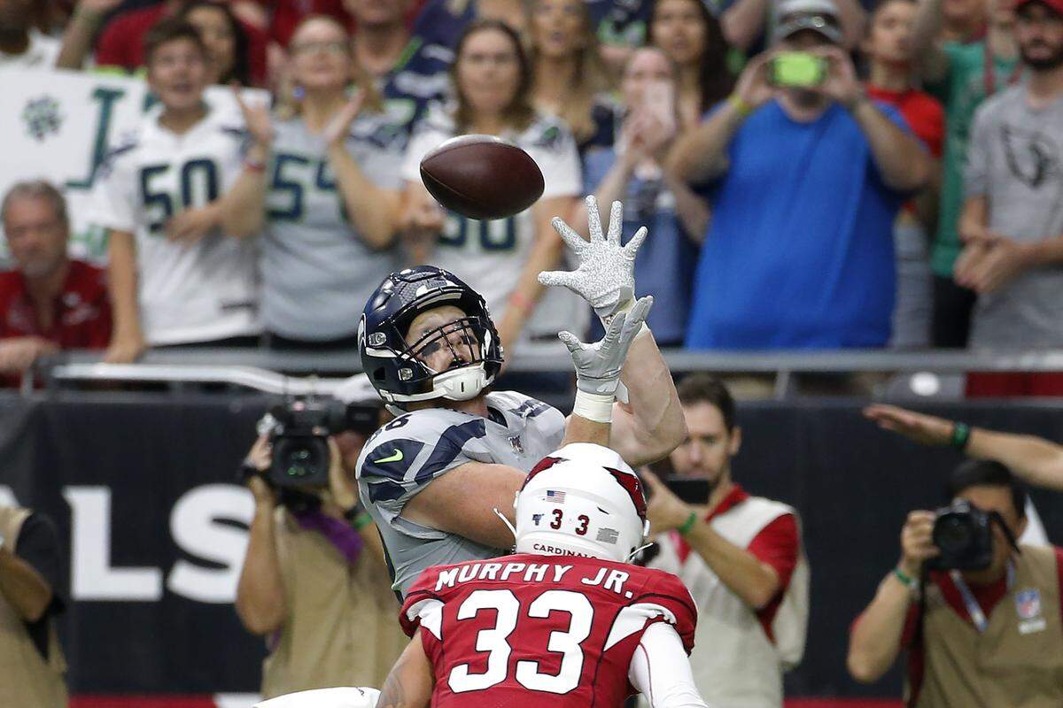 Seattle Seahawks tight end Will Dissly pulls in a touchdown pass as Arizona Cardinals cornerback Byron Murphy (33) defends during the first half of an NFL football game, Sunday, Sept. 29, 2019, in Glendale, Ariz. (AP Photo/Rick Scuteri)