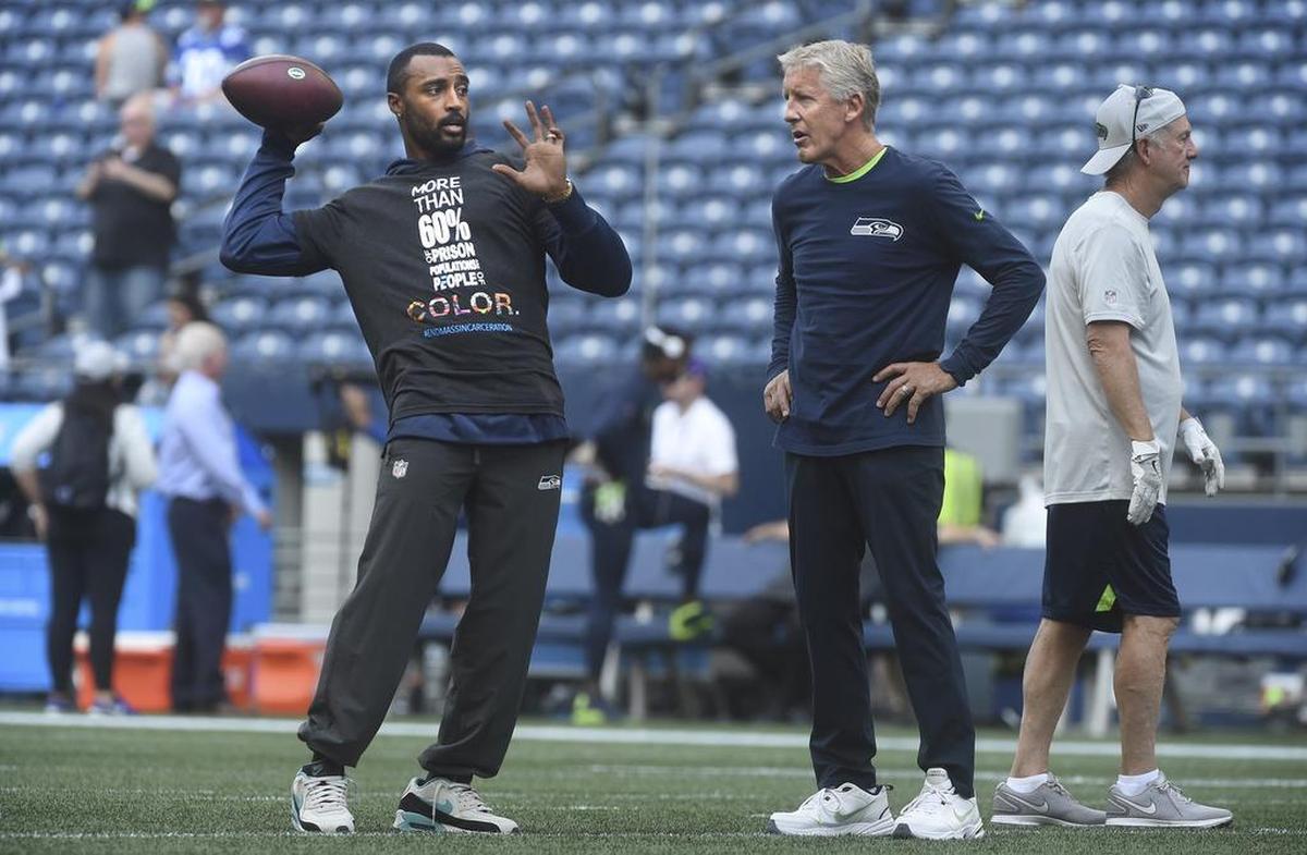 Seahawks Pro Bowl wide receiver Doug Baldwin talks with coach Pete Carroll before the preseason opener two weeks ago at CenturyLink Field. Tuesday, Carroll was his most definitive yet saying Baldwin will be back from a left-knee injury to play in the season opener Sept. 9 at Denver.