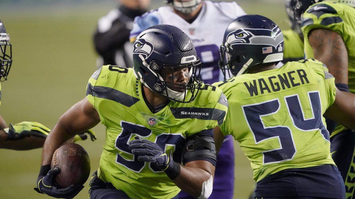 Seattle Seahawks’ K.J. Wright runs with the ball after recovering a Minnesota Vikings fumble during the second half of an NFL football game, Sunday, Oct. 11, 2020, in Seattle. (AP Photo/Ted S. Warren)