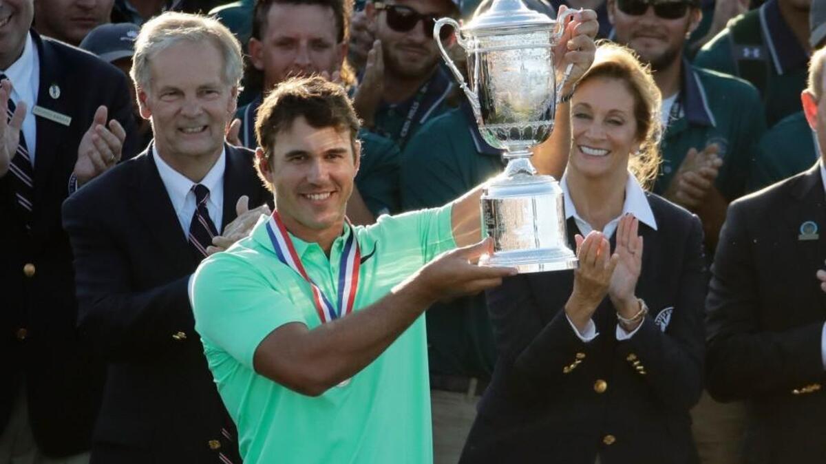 Brooks Koepka holds up the winning trophy after the U.S. Open golf tournament Sunday at Erin Hills in Erin, Wis.