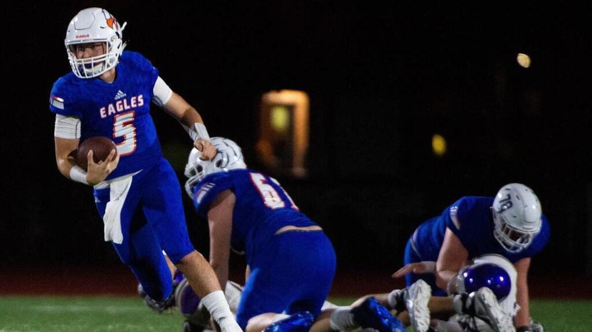 Graham-Kapowsin’s Dylan Morris (5) scrambles in the third quarter. Graham-Kapowsin played Puyallup in a football game at Art Crate Field in Spanaway, Wash., on Friday, Sept. 21, 2018.