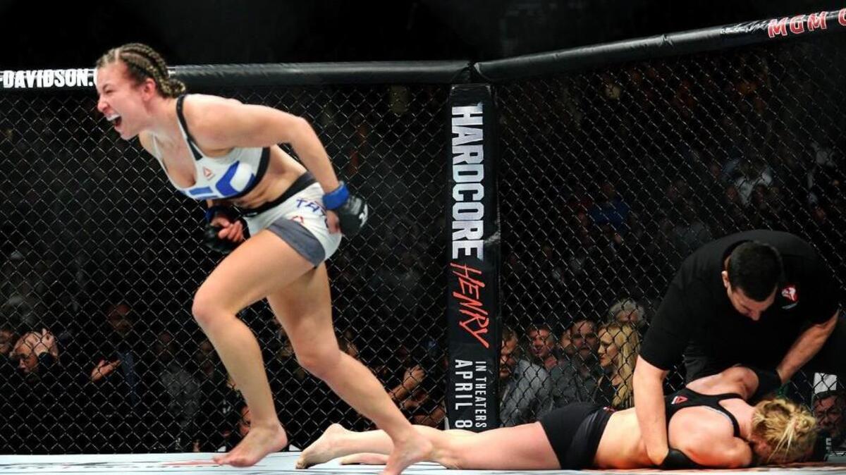 Tacoma-native Miesha Tate celebrates after defeating Holly Holm on Saturday during UFC 196 Women's Bantamweight Bout in Las Vegas.