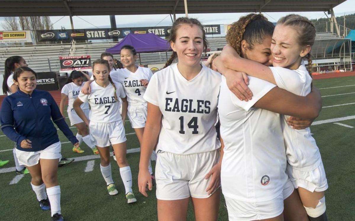Life Christian's Landyn Lovelady, right, and Naytalia Chapman embrace after the Eagles won their first girls soccer state championship, a 1-0 victory over St. George's. The lone goal was scored by Tyler Taff (14) in the first half on Saturday, Nov. 18, at Sunset Chev Stadium in Sumner.