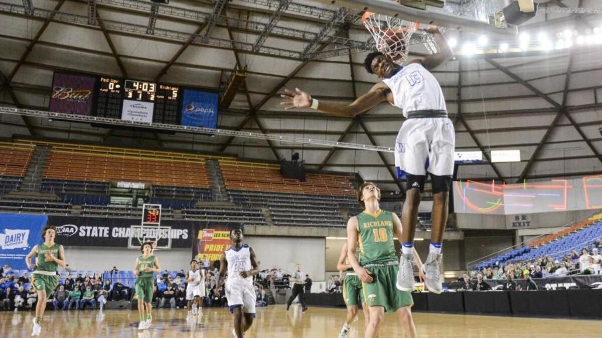 Federal Way's Etan Collins throws down a break away dunk in the first quarter. Federal Way played Richland in a basketball game at the Tacoma Dome in Tacoma, Wash., on Thursday, March 2, 2017.