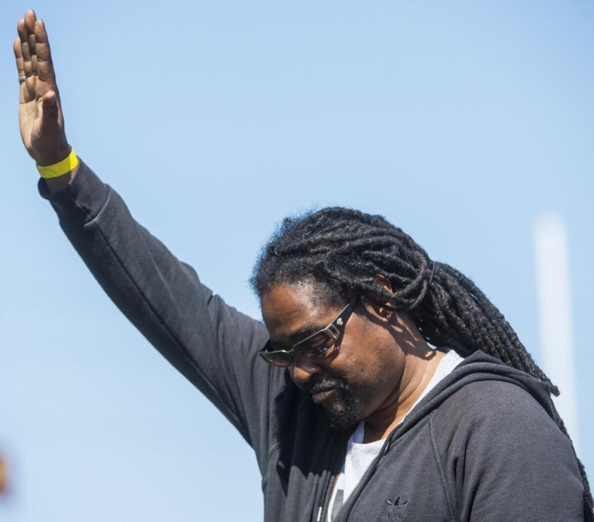 Darrell Robinson acknowledges the crowd before presenting medals at the Track and Field Championships at Mount Tahoma High School in Tacoma on Saturday, May 27, 2017.