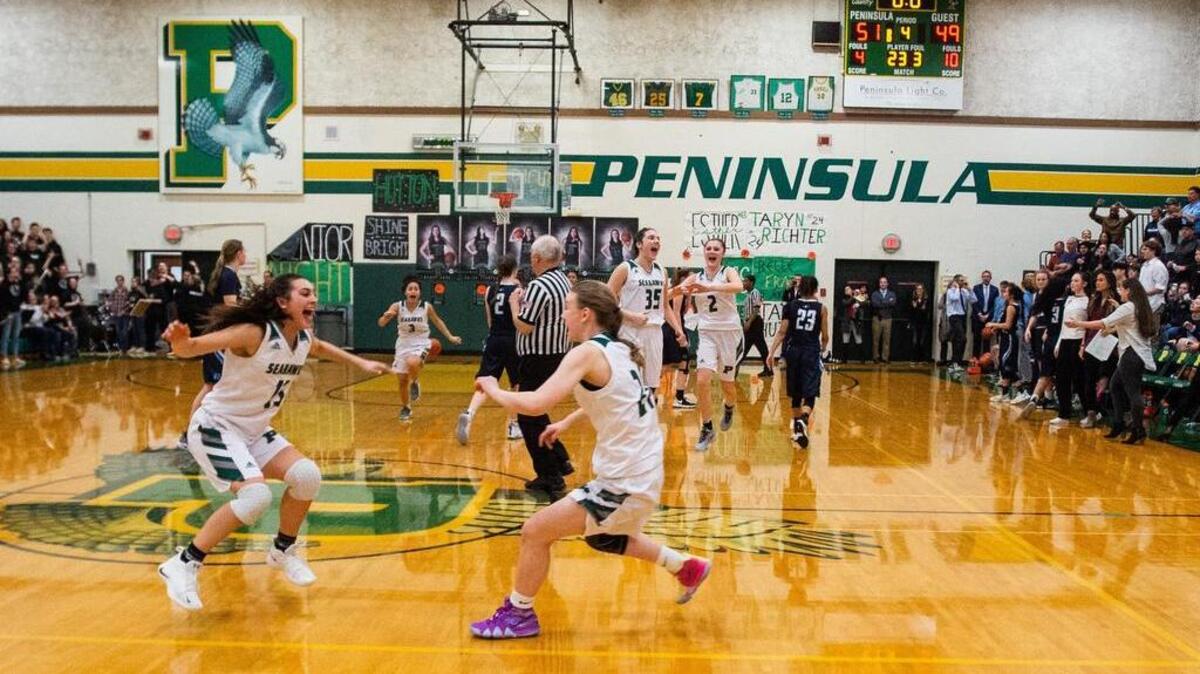 Peninsula players celebrate their win as the buzzer sounds. Peninsula played Gig Harbor in a basketball game at Peninsula High School in Purdy, Wash., on Thursday, Jan. 31, 2019.
