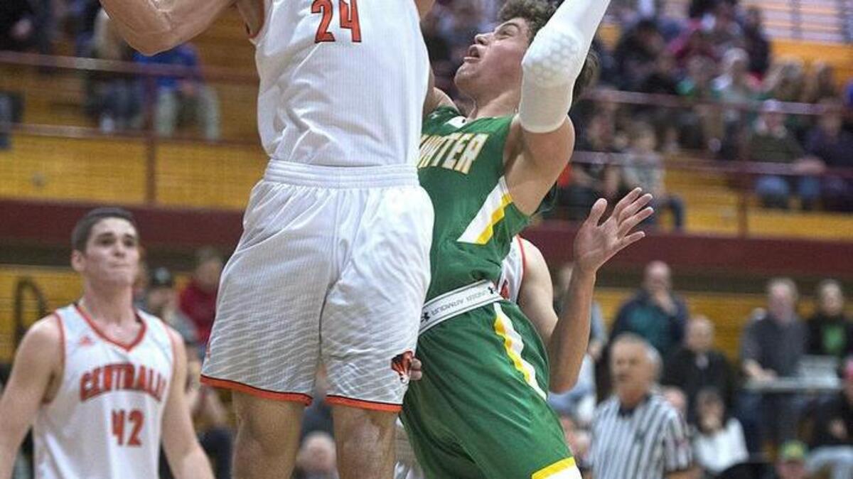 Tumwater’s Brian Marty powers to the basket against Centralia’s Jordan Thomas (24) on Thursday. Marty finished with 14 points.