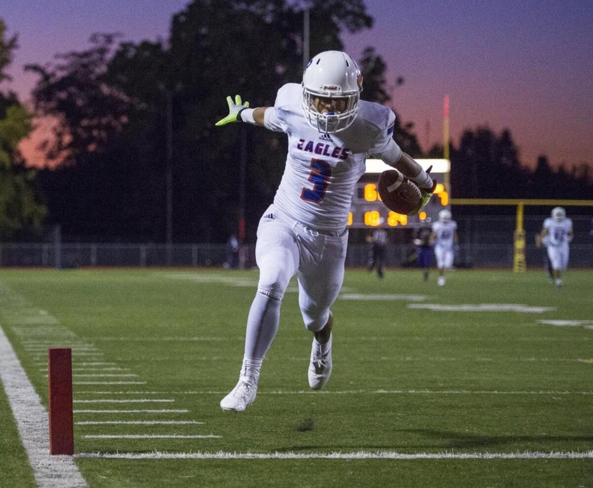 Graham-Kapowsin's Tre Mason crosses the goal line to score a touchdown in the first quarter. Graham-Kapowsin played Puyallup in a football game at Sparks Stadium in Puyallup, Wash., on Thursday, Oct. 5, 2017.