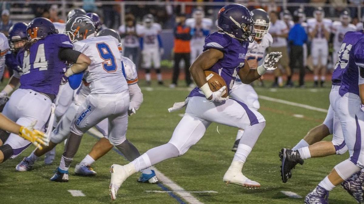 Running back Connor Wedington of Sumner High School runs past Auburn Mountainview defenders for a big gain in a 4A football game at Sunset Chev Stadium in Sumner, September 25, 2015. The UW commit begins his senior season on The News Tribune’s preseason all-state team.
