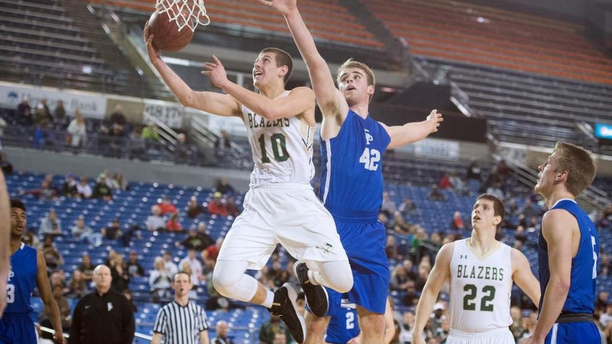 Timberline senior Erik Stevenson flies to the basket ahead of Seattle Prep defender Nic Lynch during Wednesday's opening-round game of the 3A boys basketball state tournament in the Tacoma Dome on Feb. 28, 2018.