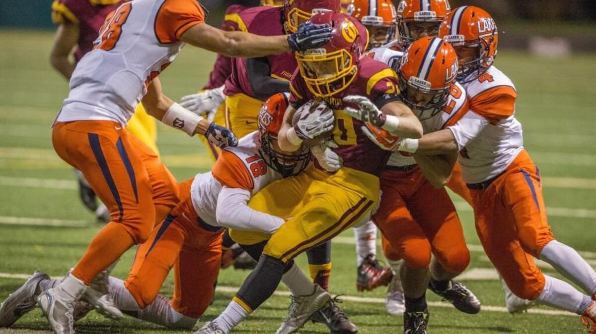 Lakes defenders swarm an O’Dea ball carrier in a 3A playoff football game at Memorial Stadium in Seattle, November 5, 2015. Lakes beat O’Dea, 56-36.