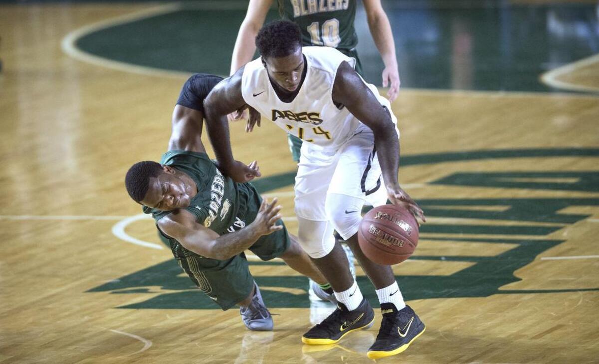 Lincoln’s Julien Simon shoves aside Timberline’s Eli Morton for a steal during Thursday’s 3A boys basketball state quarterfinals in the Tacoma Dome on March 1, 2018.