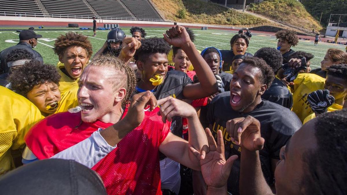 The Lincoln High School football team comes together at practice on Thursday, Aug. 23, 2018 at Lincoln Bowl.