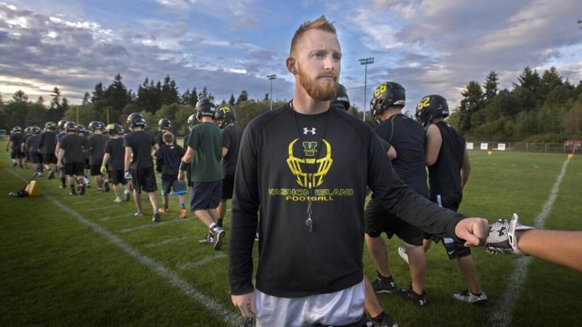 
Vashon Island coach Brynie Robinson fist bumps his player before the start of football practice at Vashon Island High School on Thursday, Sept 24, 2015.
