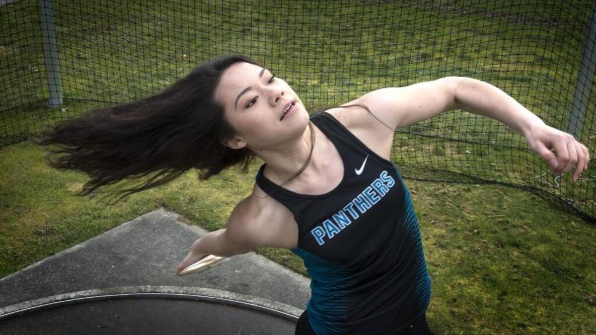 Bonney Lake's Kiana Schwendeman lets her hair and discus fly during a throw at Bonney Lake High School in Bonney Lake on Thursday, Mar. 30, 2017.
