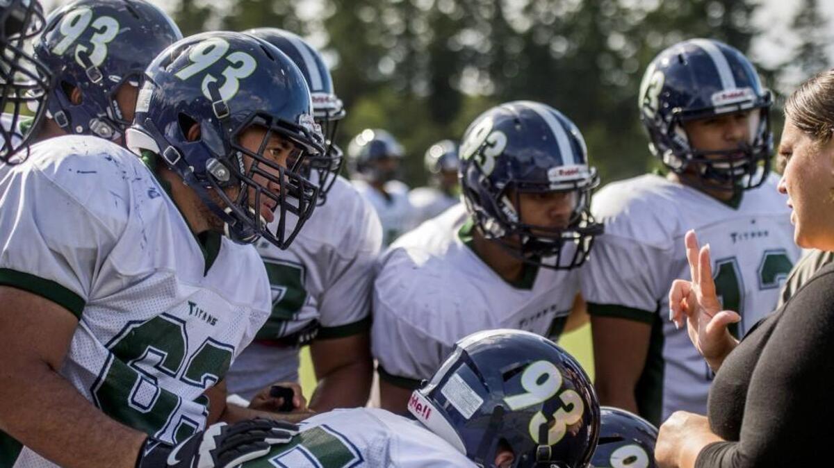 
Todd Beamer’s Daniel Tanielu, left, is hearing-impaired and relies on sign language interpreters during games, practices, meetings and all other team activities.
