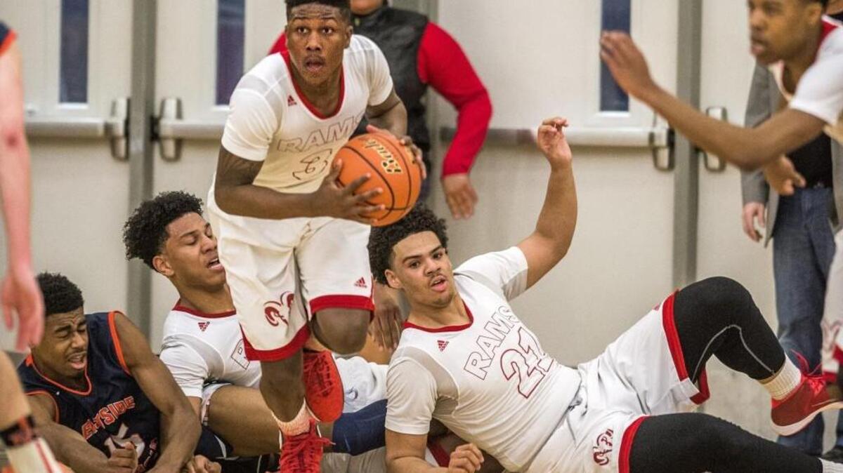 
David Jenkins of Wilson High School takes the ball upcourt as teammates Keun Palu-Thompson and Emmitt Matthews, Jr. (right) tumble behind in a WIAA Hardwood Classic 3A regional round boys basketball game played at Mt. Tahoma, February 28, 2015. Wilson lost to Eastside Catholic 53-51.

