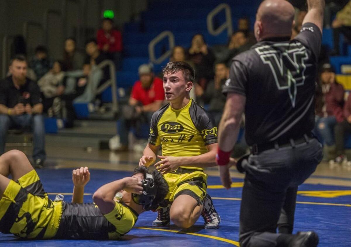 After winning the 113-pound match over Brenden Chaowanapibool of Bonney Lake (left), Haiden Drury of Toppenish kneels during the Who’s No. 1 high school wrestling tournament held at Tahoma High School in Maple Valley.
