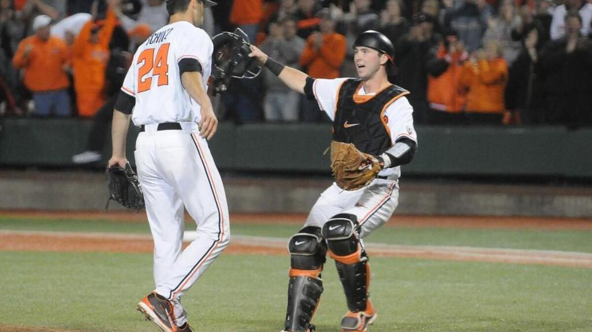 Oregon State catcher Logan Ice congratulates pitcher Scott Schultz, left, after after the team defeated UC Irvine in an NCAA college baseball regional tournament game in Corvallis, Ore., Sunday, June 1, 2014.