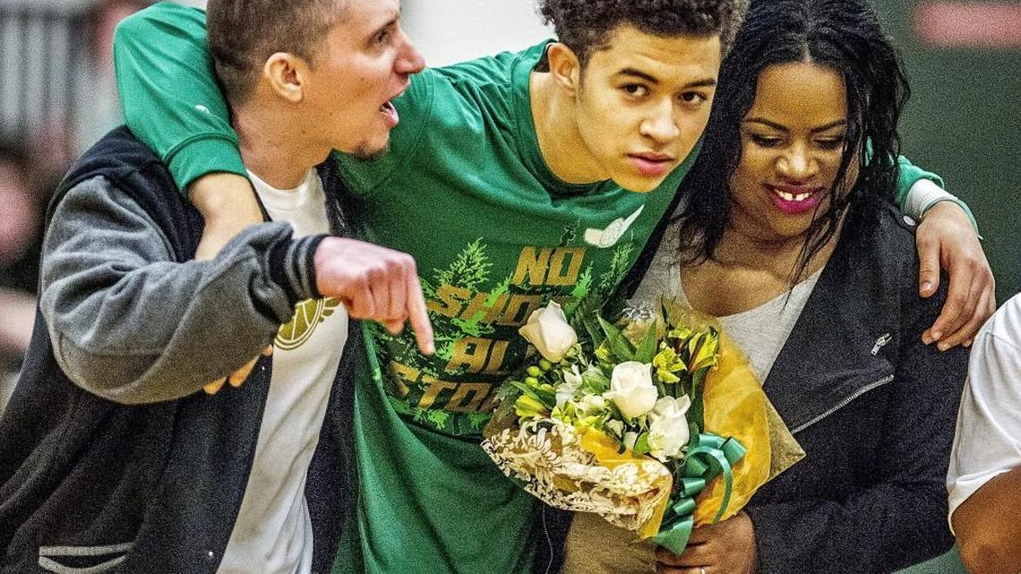 JaQouri McLaughlin with his parents before the Auburn Mountainview vs. Peninsula boys basketball game on Feb. 2 at Peninsula High School.