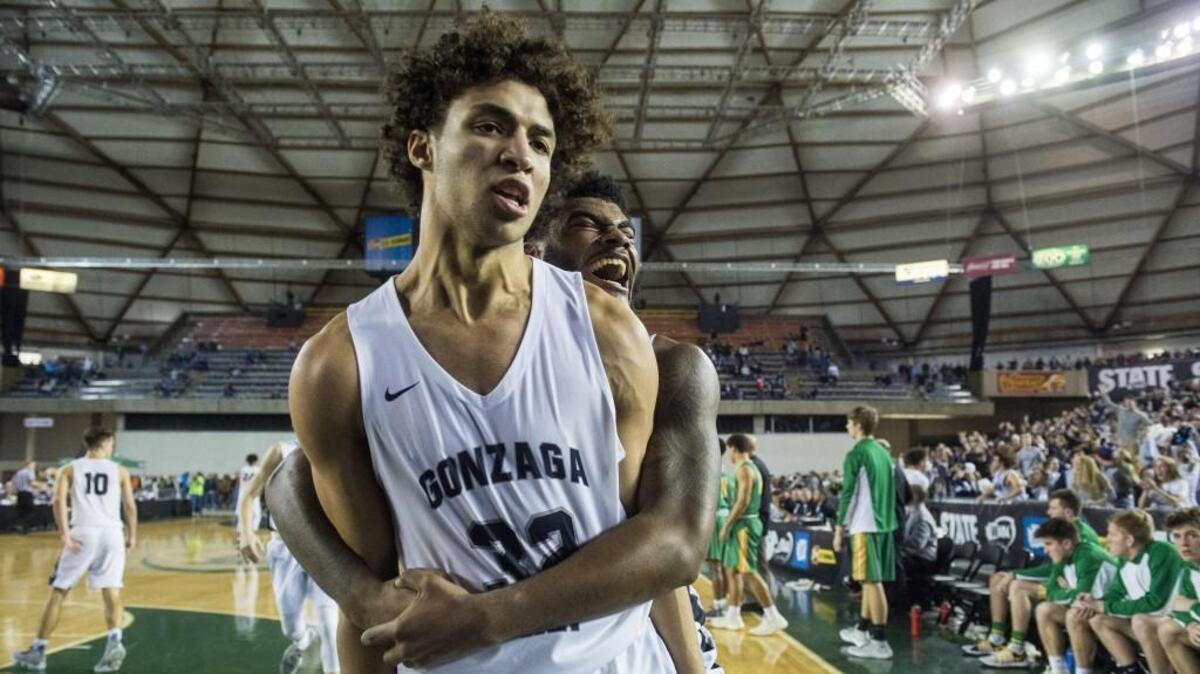 Gonzaga Prep’s Anton Watson (32) and Devin Culp (20) celebrate Watson’s game-winning three point shot. Richland played Gonzaga Prep in a semifinal bracket game at the Hardwood Classic state basketball tournament at the Tacoma Dome in Tacoma, Wash., on Friday, March 2, 2018.