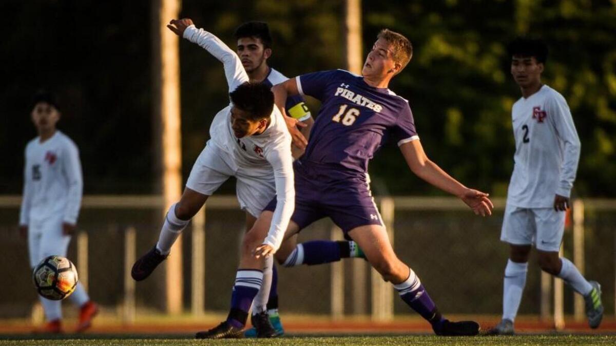 Franklin Pierce's Matthew Soeum and Highline's Jack Madsen (16) collide while fighting for possession in the first half. Franklin Pierce played Highline in a soccer match at Franklin Pierce High School in Tacoma, Wash., on Saturday, May 12, 2018.