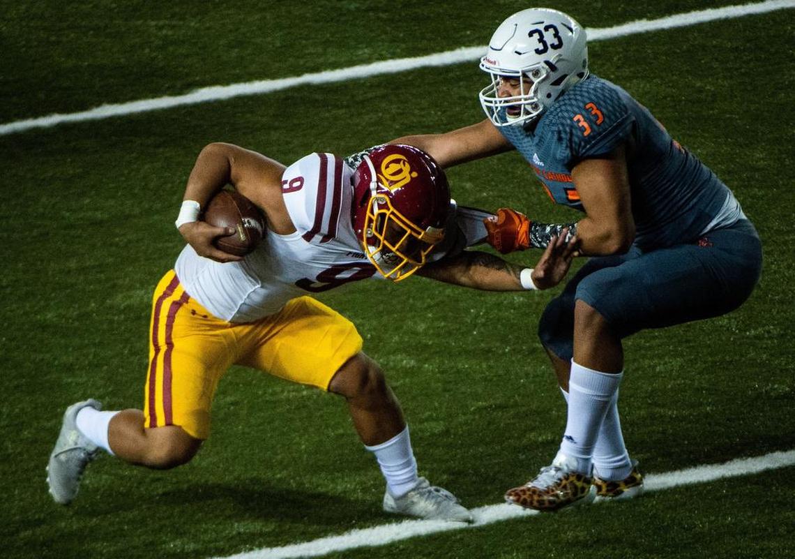 Eastside Cathoic’s Jaylahn Tuimoloau (33) tackles O’Dea’s Mark Tafia in the second quarter. Eastside Catholic played O’Dea in the WIAA 3A football state championship game at the Tacoma Dome in Tacoma, Wash., on Friday, Nov. 30, 2018.