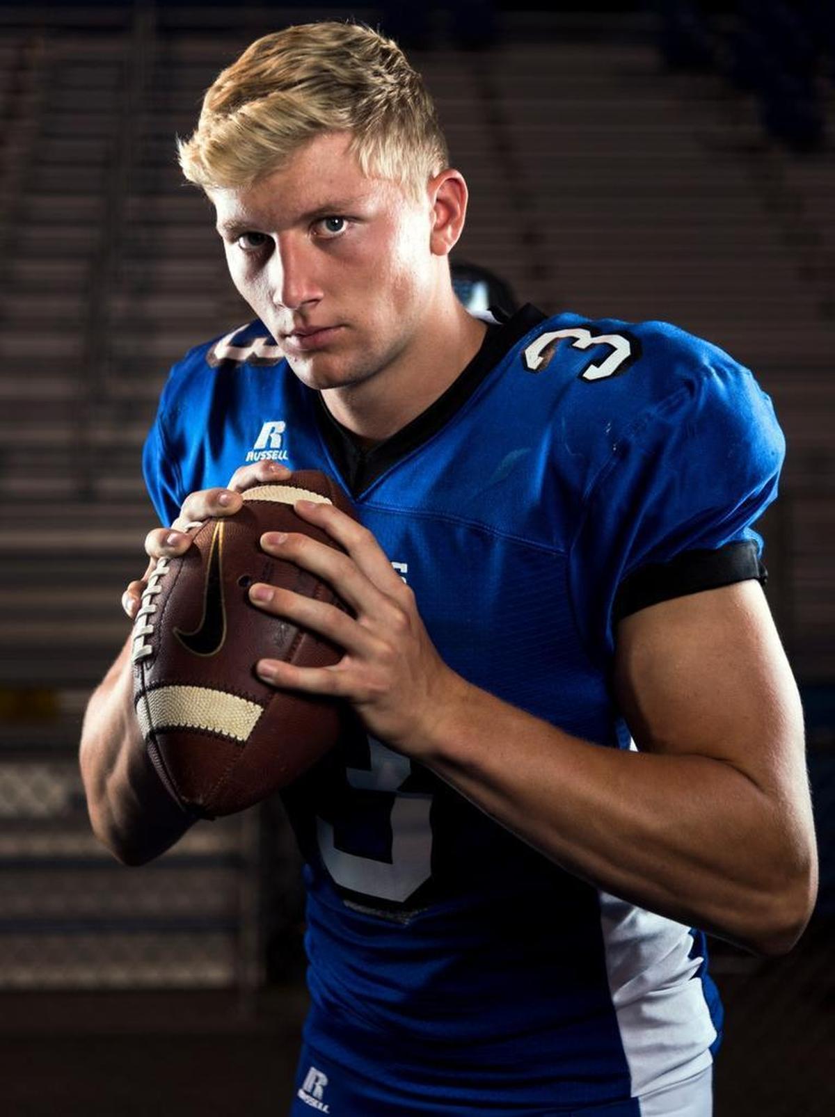 Coeur d’Alene High School quarterback Colson Yankoff poses for a portrait on the school’s field.