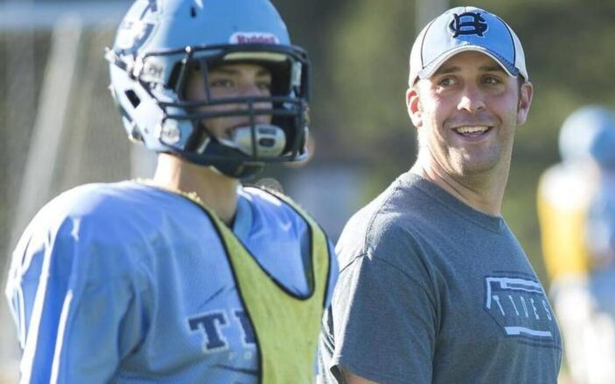 Gig Harbor coach Aaron Chantler chats with wide receiver/cornerback Zack Davis. Chantler is now the offensive coordinator at Auburn High School, coaching under his father-in-law, Gordy Elliott.