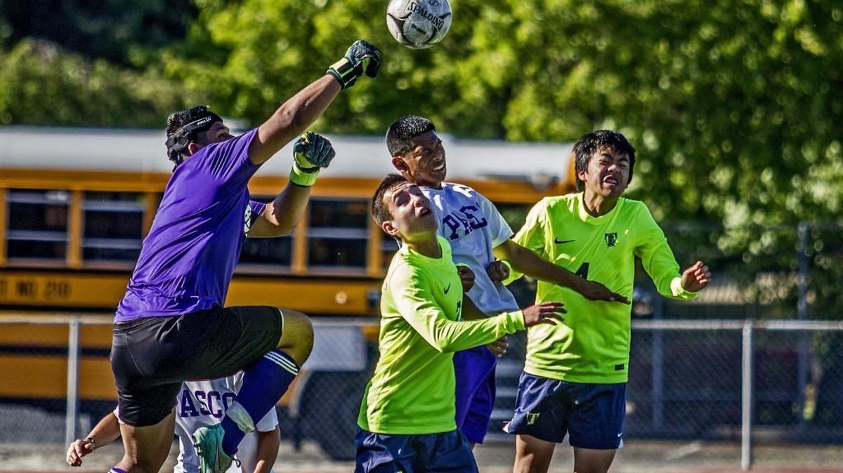 Bulldog goalkeeper punches the ball to safety late in the first half of Todd Beamer vs. Pasco in the 4A soccer state finals at Sparks Stadium in Puyallup, Wash., Saturday, May 27, 2017. The match is tied 1-1 at the half.