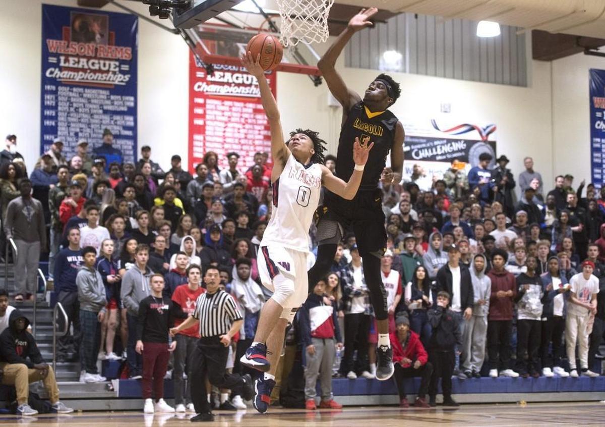 Lincoln's Willie Thomas III chases down Wilson's Damani Green for a blocked shot during Wednesday night's boys basketball game at Wilson High School in Tacoma on Jan. 24, 2018.