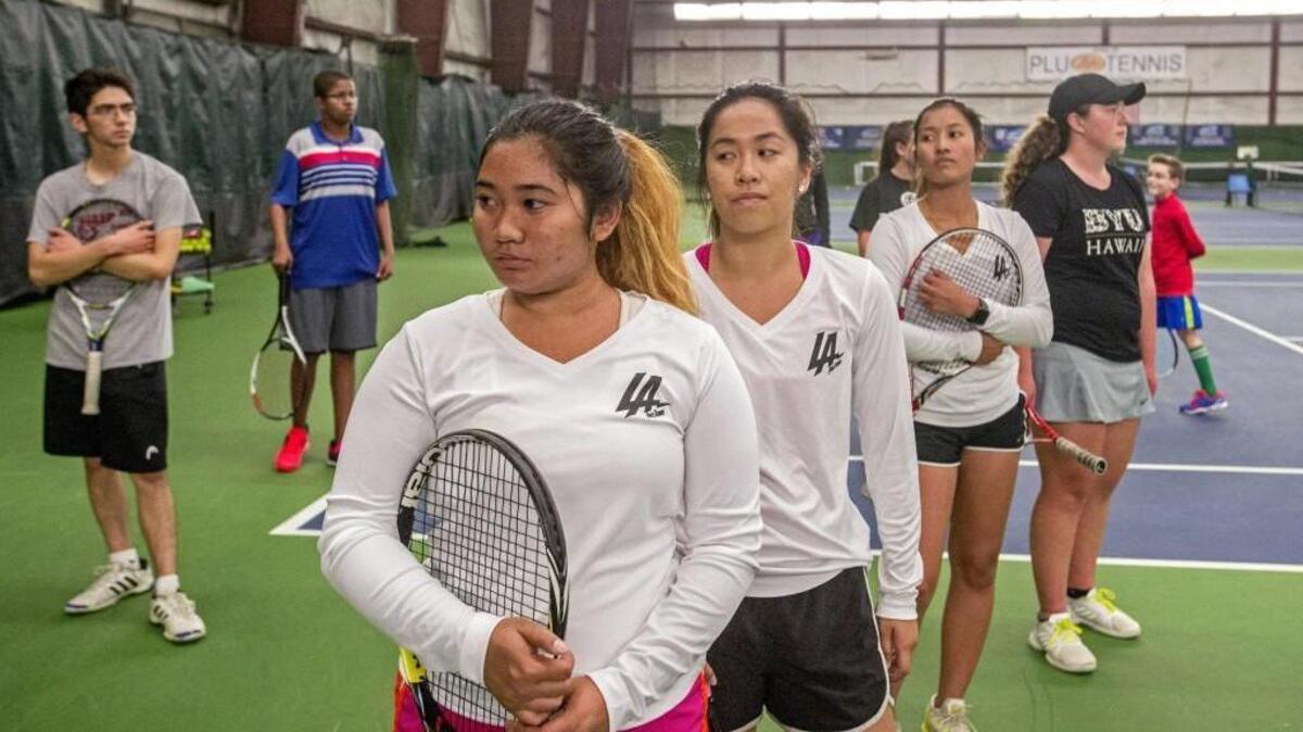 Alexis Choy (foreground) and Amy Hung (behind) make the top doubles team for Lincoln's girls tennis team. Here they, teammates, and players from other schools get some dry court practice on a rainy day at Sprinker Rec Center in Spanaway, May 16, 2017.