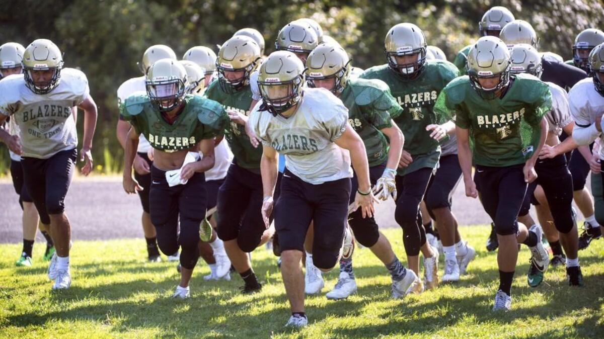 Michael Barnes (center) is expected to be a big playmaker for Timberline as the program looks to defend its league title.