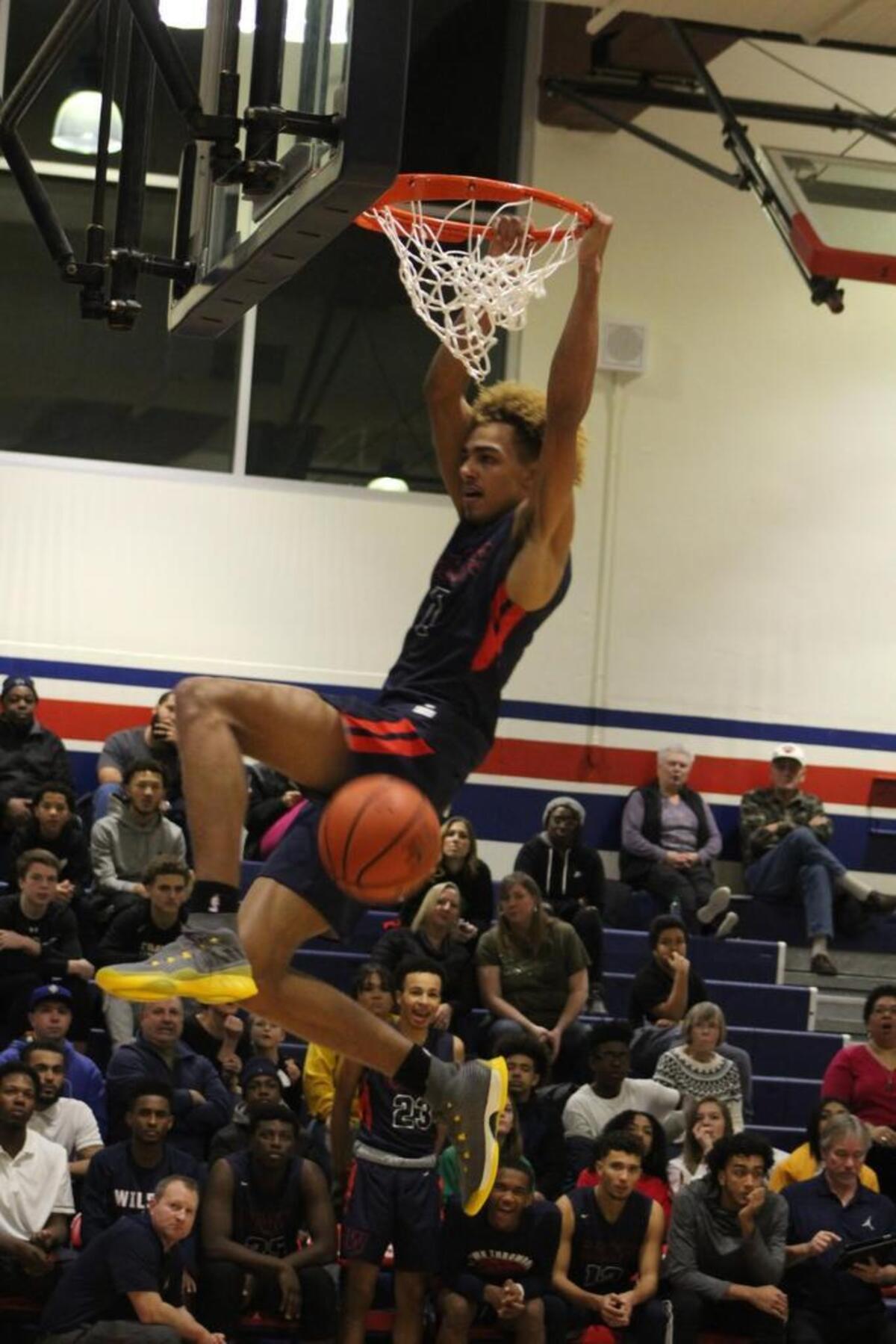 Wilson’s Emmitt Matthews Jr., a UConn signee, rocks the rim on his way to a game-high 18 points in the Rams’ win over Puyallup for the title at the T-Town Throwdown at Wilson High School on Friday.