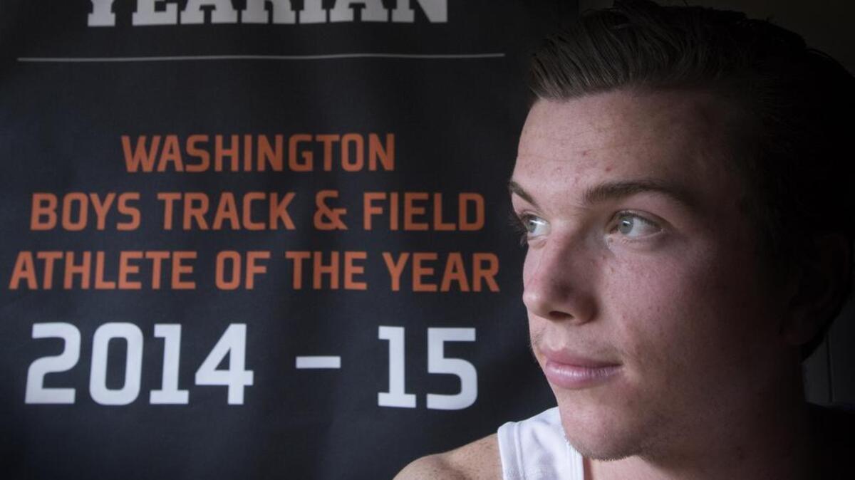 Jack Yearian with his Gatorade Player of the year award that won last year, in back, looks toward the upcoming state track tournament at Bellarmine Prep on Tuesday, May 24, 2015. The University of Oregon commit and reigning Gatorade state track and field athlete of the year is going for back-to-back state titles in the 1,600 and 3,200 after coming off a 4A state cross country title in the fall.