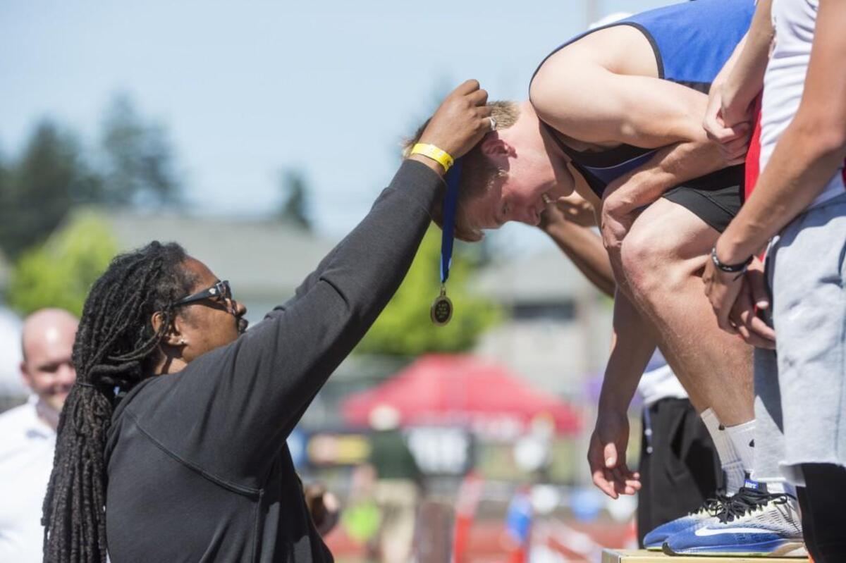 Darrell Robinson presents medals at the Track and Field Championships at Mount Tahoma High School in Tacoma on Saturday, May 27, 2017.