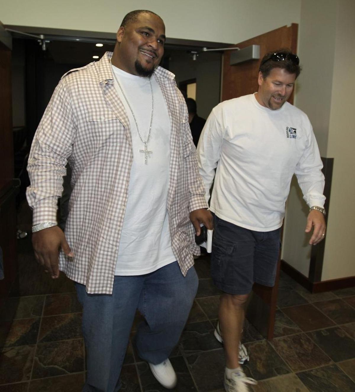 Seattle Seahawks left tackle Walter Jones, left, leaves a news conference with former Seahawks' teammate Robbie Tobeck, right, where Jones talked about his retirement from NFL football, Friday, April 30, 2010, at Seahawks headquarters in Renton, Wash. Both Jones and Tobeck have sons who are seniors playing high school football this year, with Walterius Jones at Lake Washington High School and Madden Tobeck at Cascade Christian.