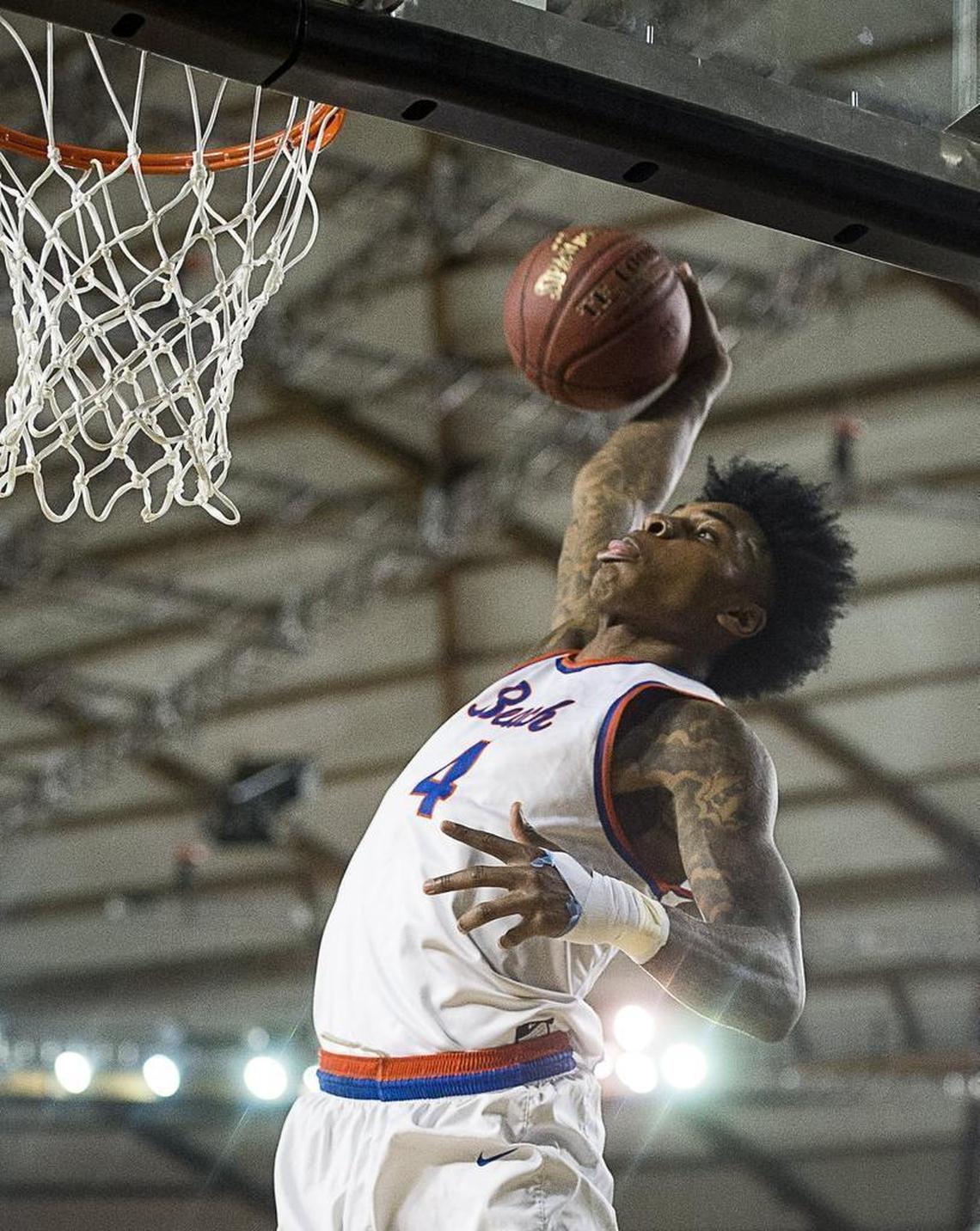 Rainier Beach's Kevin Porter goes up for a windmill dunk in the third quarter. Wilson played Rainier Beach in a basketball game during the Hardwood Classic state basketball tournament at the Tacoma Dome in Tacoma, Wash., on Thursday, March 1, 2018.