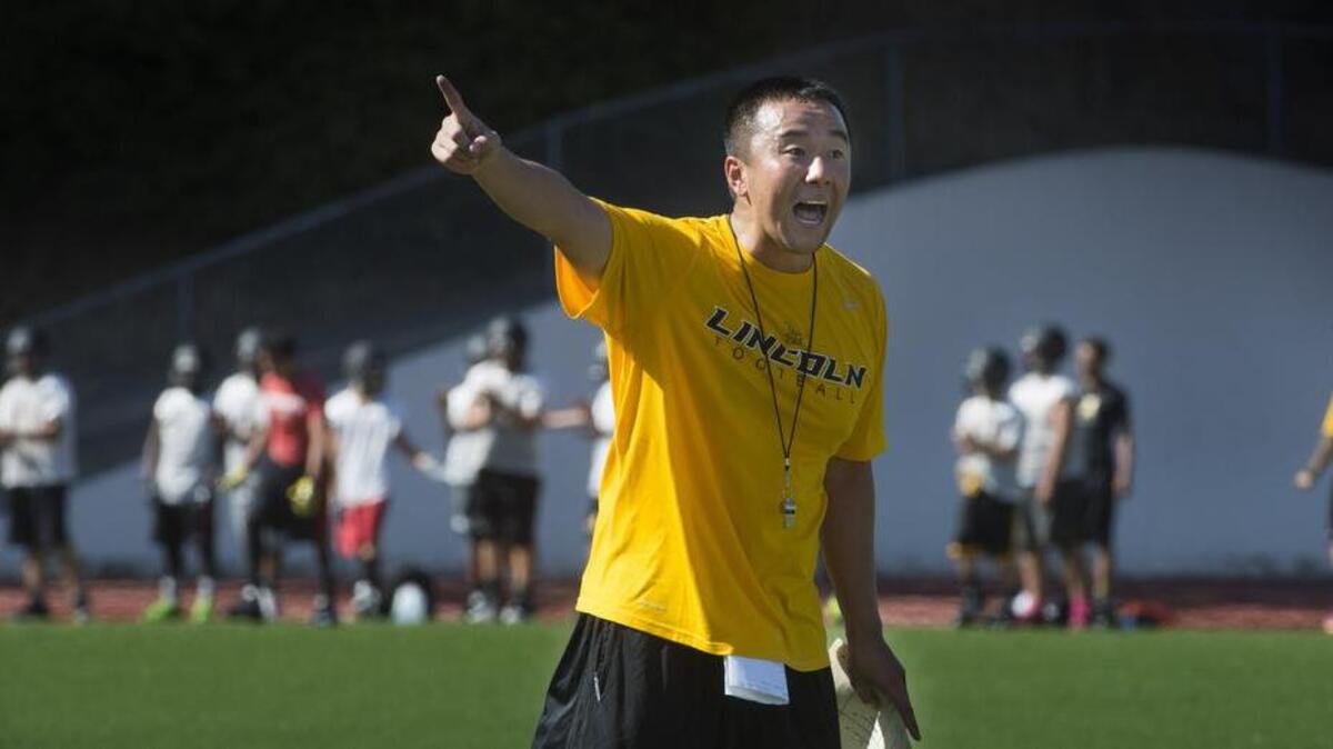 
First-year Lincoln High football coach Masaki Matsumoto yells out instructions to his players during the Abes’ first practice at Lincoln High School on Wednesday. Matsumoto, a highly successful coach in California, replaces equally successful Jon Kitna.

