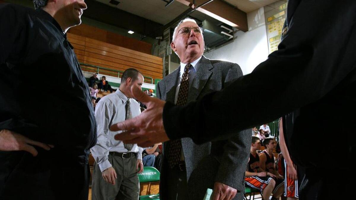 Centralia head coach Ron Brown talks with friends before a boys basketball game at Tumwater High School on Dec. 12, 2008.