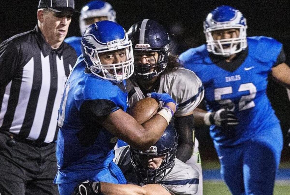 Federal Way High School running back Alphonzo Tuputala grinds out yardage and scores the Eagles’ second touchdown to tie the Todd Beamer Titans, 14-14, at halftime on Friday, Sept. 23, 2016.