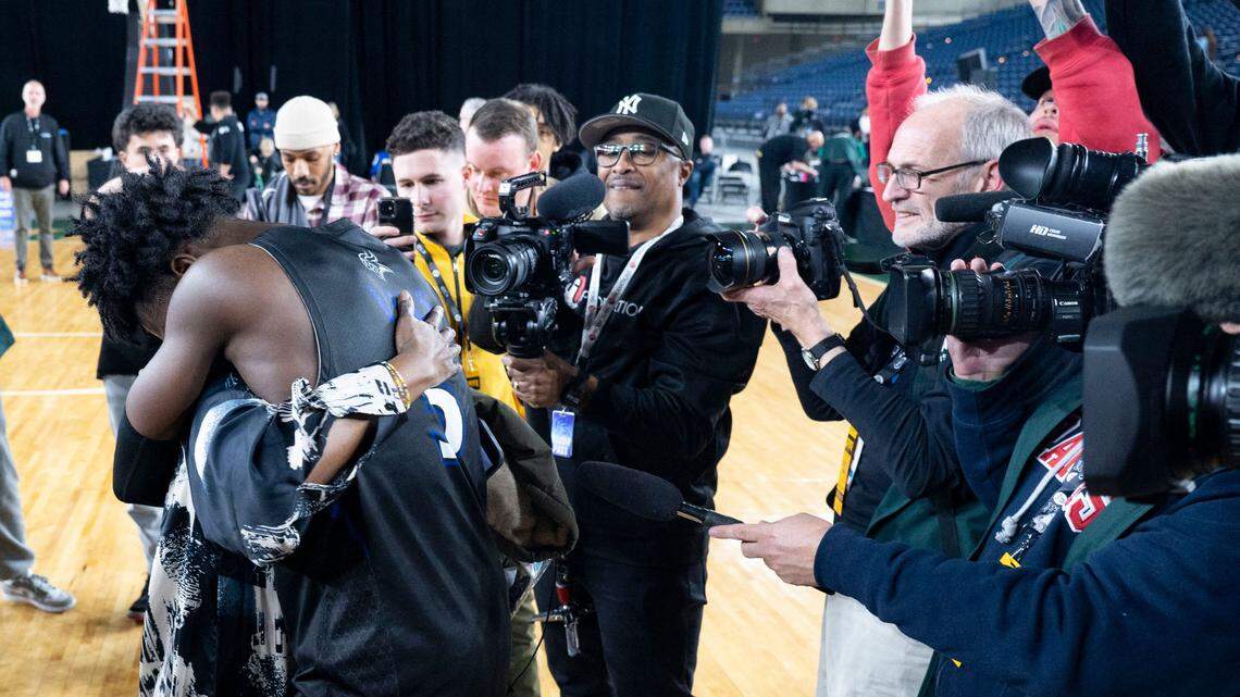 Curtis guard Zoom Diallo (5) hugs his mother, Adja Diallo, after his team beat Olympia to win the Class 4A championship game on Saturday, March 4, 2023, in Tacoma, Wash.