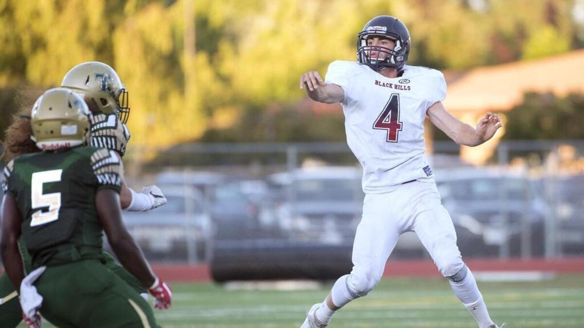 Black Hills quarterback Ethan Loveless tries to finesse a pass over the Timberline defense, only to have it intercepted by Blazer linebacker Ty Edmond (5) for a pick-six touchdown early Thursday night’s season-opening football game at South Sound Stadium in Lacey on Aug. 31, 2017.