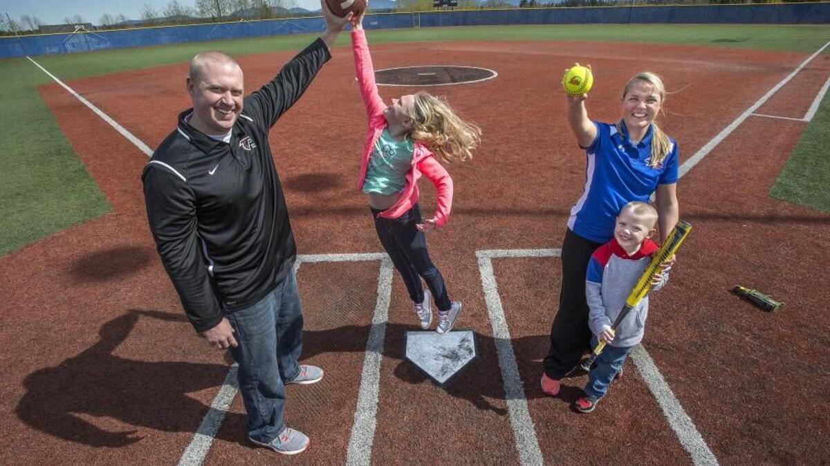 Auburn Mountainview softball coach Alicia Thompson, right, and husband, Kentlake football coach Brett Thompson, left, share a busy life coaching and raising kids Kyla, 8 and son Brodie, 5. Alicia is hoping to lead her Lions to state for the third consecutive year.