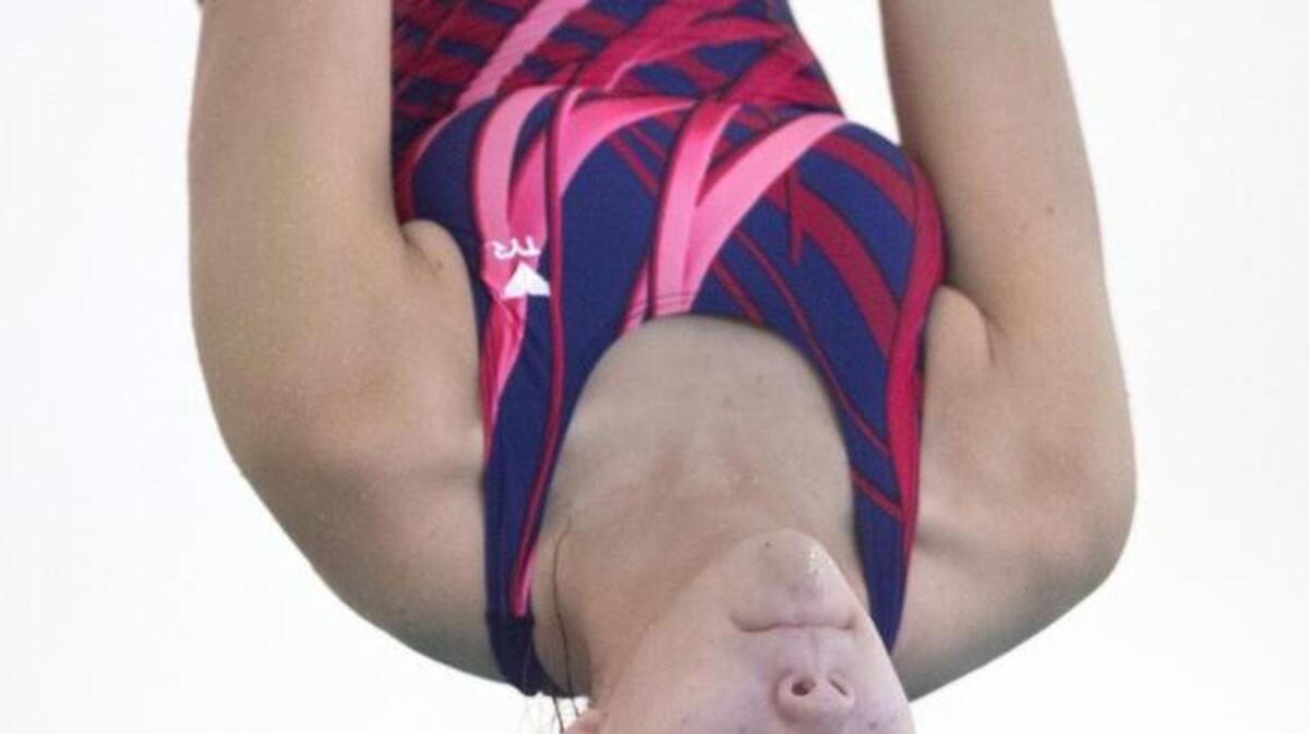 Black Hills sophomore diver CeCe Pennella eyes the water as she spins out of a back somersault during a swim meet with Tumwater and River Ridge at River Ridge High School on Oct. 20. Pennella used her experience as a former Level 8 gymnast to excel at diving for the Wolves swim team.
