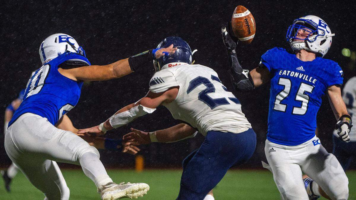 Eatonville defensive lineman Chase Grant (25) intercepts a screen pass that was intended for Lynden Christian’s Caleb Ryan but was tipped by Antonio Accarino (20) during the second quarter of a State 1A semifinal game on Saturday afternoon at Art Crate Field in Spanaway.